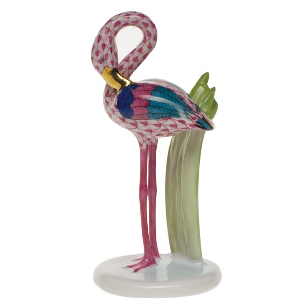 A Herend Little Flamingo, Raspberry Pink porcelain figurine of a flamingo standing on top of a plant, from Herend.