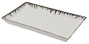 The Pigeon & Poodle Rio Silver and White Tray is a rectangular porcelain tray with raised edges, dark decorative pattern, and a subtle metallic silver drip along the rim.