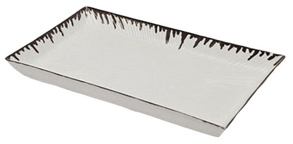 The Pigeon & Poodle Rio Silver and White Tray is a rectangular porcelain tray with raised edges, dark decorative pattern, and a subtle metallic silver drip along the rim.
