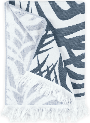 The Matouk Zebra Palm Beach Towel in navy features a folded, fringed design with zebra-like patterns, ideal for adding an exotic and sophisticated touch as either a towel or a stylish accent piece.