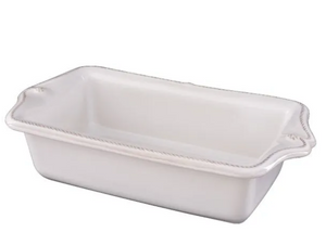 The Juliska Berry & Thread Whitewash Loaf Pan is a rectangular ceramic stoneware piece with decorative edges, shown at an angle on a plain white background.