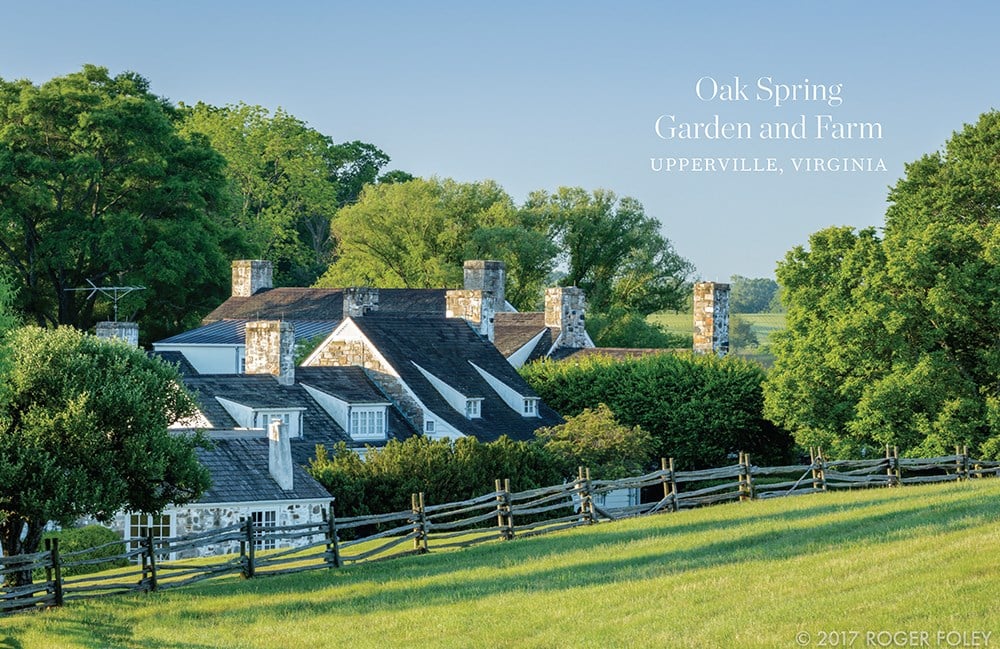 A stone farmhouse with multiple chimneys, surrounded by greenery and a wooden fence that channels Bunny Mellon's iconic garden design, is labeled "Oak Spring Garden and Farm, Upperville, Virginia," reminiscent of the style showcased in "Gardens of Bunny Mellon" by Common Ground.