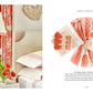 A bedroom features coral-themed decor with curtains and pillows on the left. On the right, The Principles of Pretty Rooms by Abrams presents fabric swatches in coral and beige, showcasing timeless interiors for elegant spaces.