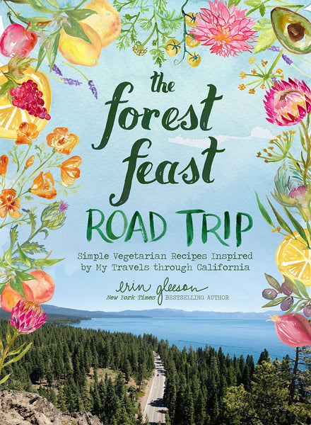 Cover of the 'Common Ground Forest Feast Road Trip' cookbook by Erin Gleason, featuring scenic road view and illustrated fruits and flowers.