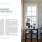 Interior design showcase featuring an At Home on the Water retreat room with a Common Ground grandfather clock, elegant lamp, and soft color palette.