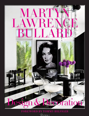 The book "Design & Decoration" by Martyn Lawrence Bullard, published by Penguin Random House, features luxury interiors in monochrome with pink-accented text and a woman’s photograph on the cover. Foreword by Tommy Hilfiger.