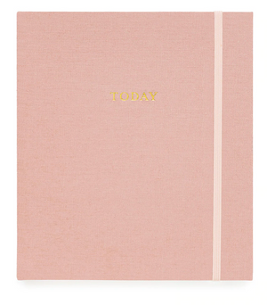 A pink fabric-covered journal with the word "Today" written in gold letters on the cover and a light pink elastic band on the right side—Sugar Paper's The Mindful Journal, Pink—a perfect companion for boosting daily productivity and recording your journey to happiness.