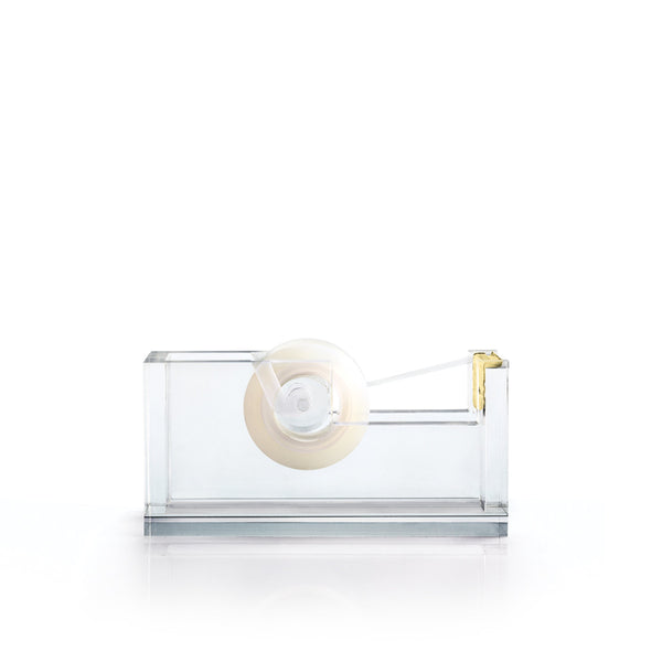 A Russell & Hazel Acrylic tape dispenser with gold-toned hardware on a white surface.