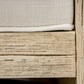 Close-up of an Almario Lounge Chair by PALECEK with a vintage white finish and a white cushion. The wooden frame features textured, weathered wood with horizontal grain patterns.