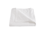 A Matouk Ansonia Bedding Collection, White blanket draped on a white background.