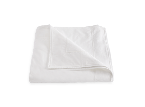 A Matouk Ansonia Bedding Collection, White blanket draped on a white background.