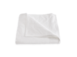 A Matouk Ansonia Bedding Collection, White blanket draped on a white background.