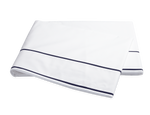 The Ansonia Bedding Collection by Matouk features a neatly folded white bedsheet with two thin navy blue stripes near the edge, crafted from luxurious 500 thread count Egyptian cotton percale.