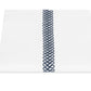 Matouk's Astor Braid Bedding Collection in Indigo features white Ceylon percale with a single vertical navy blue embroidered loop, inspired by Schumacher’s classic design.