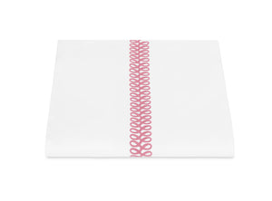 A folded white sheet from the Matouk Astor Braid Bedding Collection in Peony, featuring a vertical pink embroidered loop design, displayed on a white background.