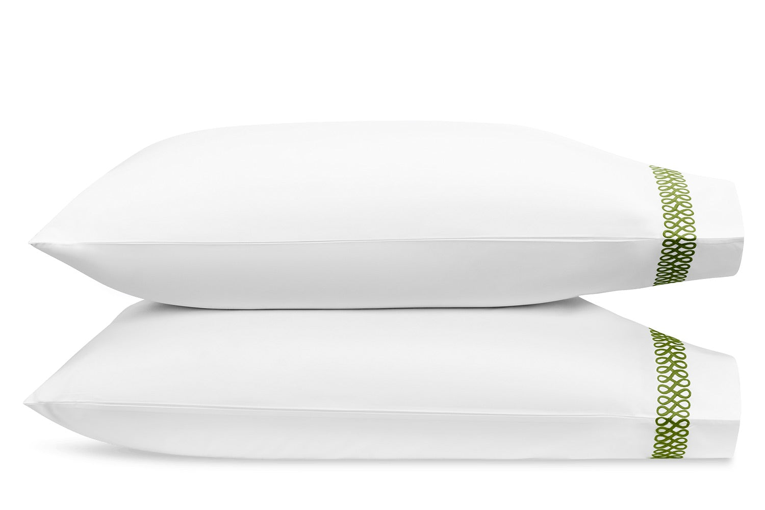 Two white pillows with a green border on the right edge display the Astor Braid Bedding Collection in Grass by Matouk, crafted from luxurious 520 thread count fabric.