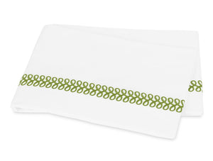 An embroidered Matouk Astor Braid Bedding Collection, Grass sheet with green trim, made from Ceylon percale fabric.