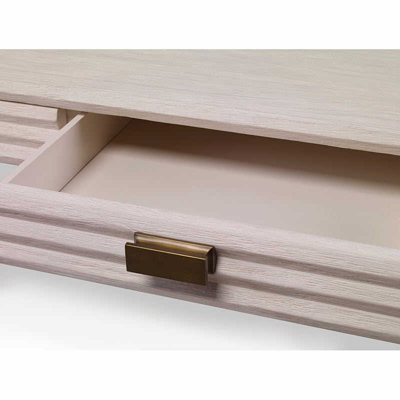 The Belmont Small Desk by Mr Brown showcases a light wood drawer with a brass handle, resembling elegant desk storage and partially open to reveal an empty interior.