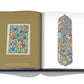 An open book showcasing colorful, intricate floral designs on both pages reflects cross-cultural influences. The left page features a rectangular artwork, while the right page displays a long, vertically oriented design from the Boghossian by Assouline.