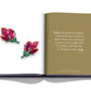 Open book displaying two pages; left page shows two exceptional gemstone brooches from Assouline jewelers, shaped like flowers with ruby and green stones. The right page contains a block of text with a quote about exotic tulips in Ottoman society, highlighting cross-cultural influences.