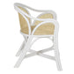 The Bolinas Dining Chair by Selamat features a side view of a white wicker design with curved arms, cane weave backing, natural finish, and an open seat design.
