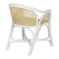 The Bolinas Dining Chair by Selamat is a white wicker dining chair featuring armrests, a curved backrest, a rattan back panel, and a beautifully crafted cane weave seat.