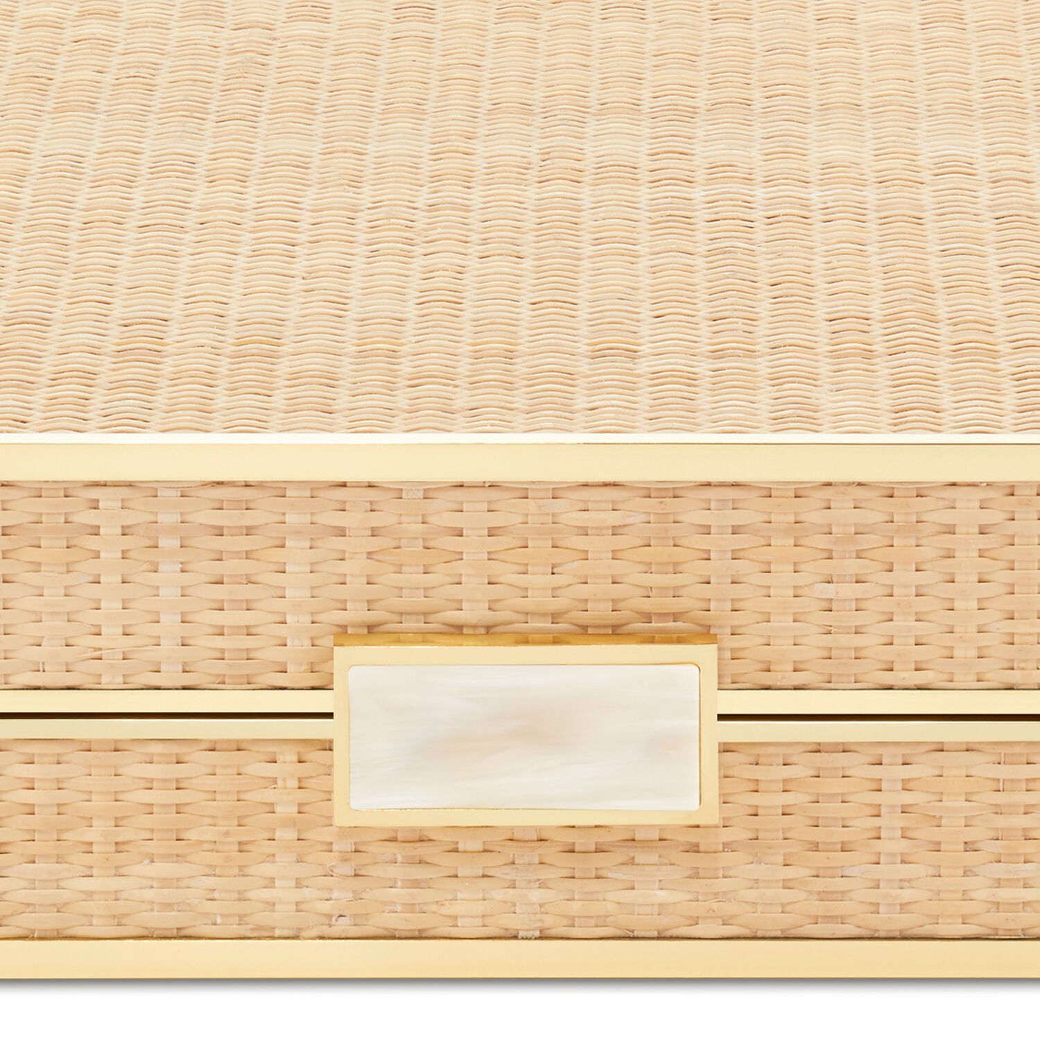 A close-up of the Aerin Cane Backgammon Set, a rectangular woven rattan box featuring brass hardware and a gold-trimmed ivory handle on the front.