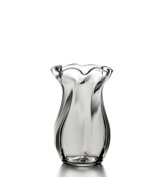A Simon Pearce Chelsea Optic Vase, Small with a wavy shape on a white background.