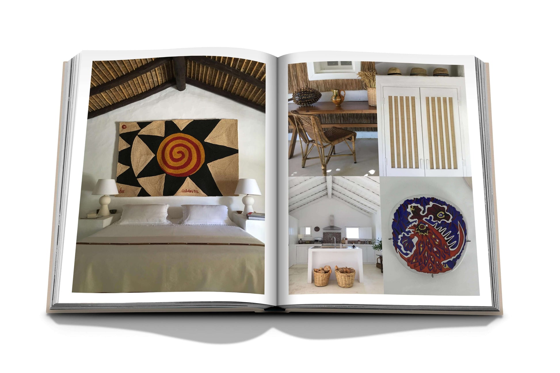 An open magazine features interior design photos, including a bedroom with patterned wall art, a decorated living space inspired by Comporta's artistic community, a kitchen, and colorful circular artwork showcasing "Comporta Bliss" by Assouline.
