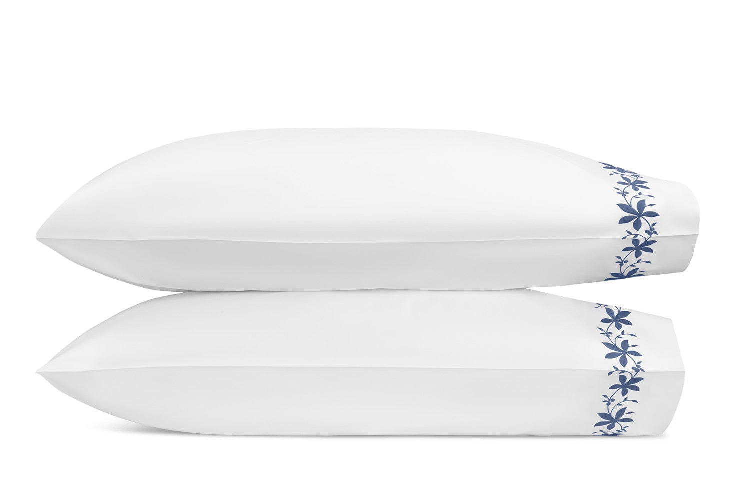Two white pillows made of 500 thread count Egyptian cotton percale with blue floral patterns on one end, stacked against a white background from the Matouk Callista Bedding Collection, Bluebell.