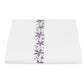 White square dinner plate with a Matouk Callista Bedding Collection, Lilac design running down the center, isolated on a white background.