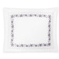 The Callista Bedding Collection in Lilac by Matouk features a white rectangular design with a purple floral border reminiscent of decorative embroidery, set against a plain white background.