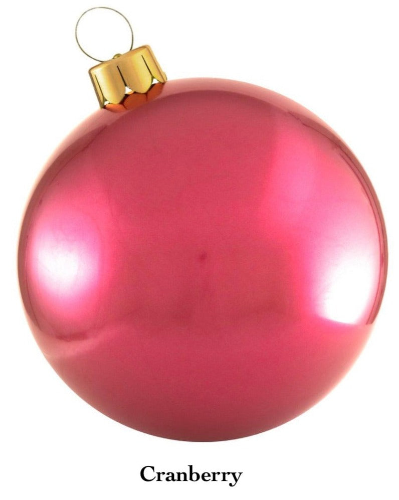 The Holiball Giant Inflatable Ornament by Holiball, featuring a glossy cranberry hue and a gold cap that evokes the charm of traditional holiday decorations, is presented against a white backdrop.