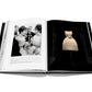 An open book reveals a black-and-white photo of people interacting on the left page, while the right page showcases a vintage dress, embodying fashion treasures reminiscent of Dior III by Marc Bohan from Assouline.