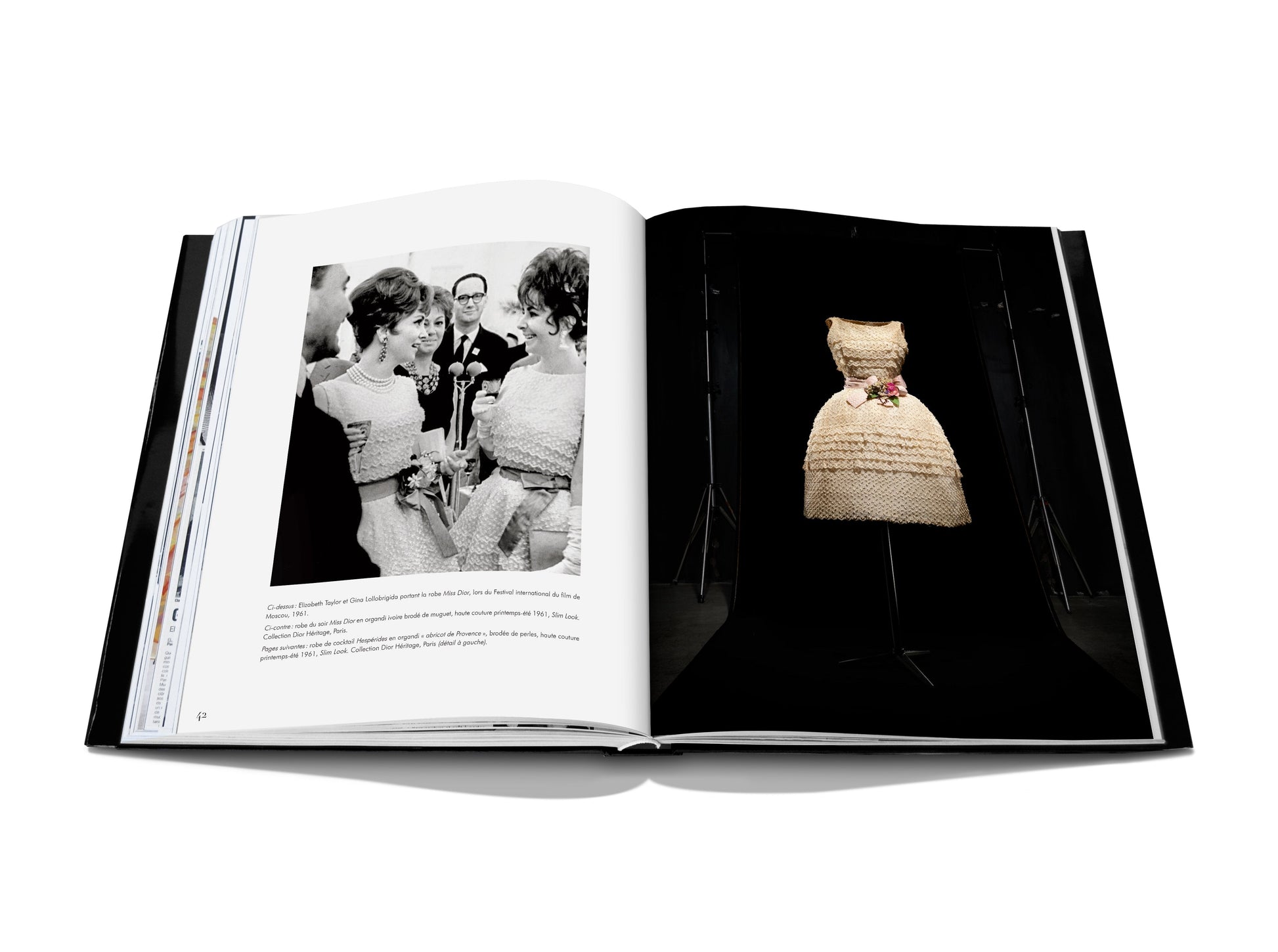 An open book reveals a black-and-white photo of people interacting on the left page, while the right page showcases a vintage dress, embodying fashion treasures reminiscent of Dior III by Marc Bohan from Assouline.