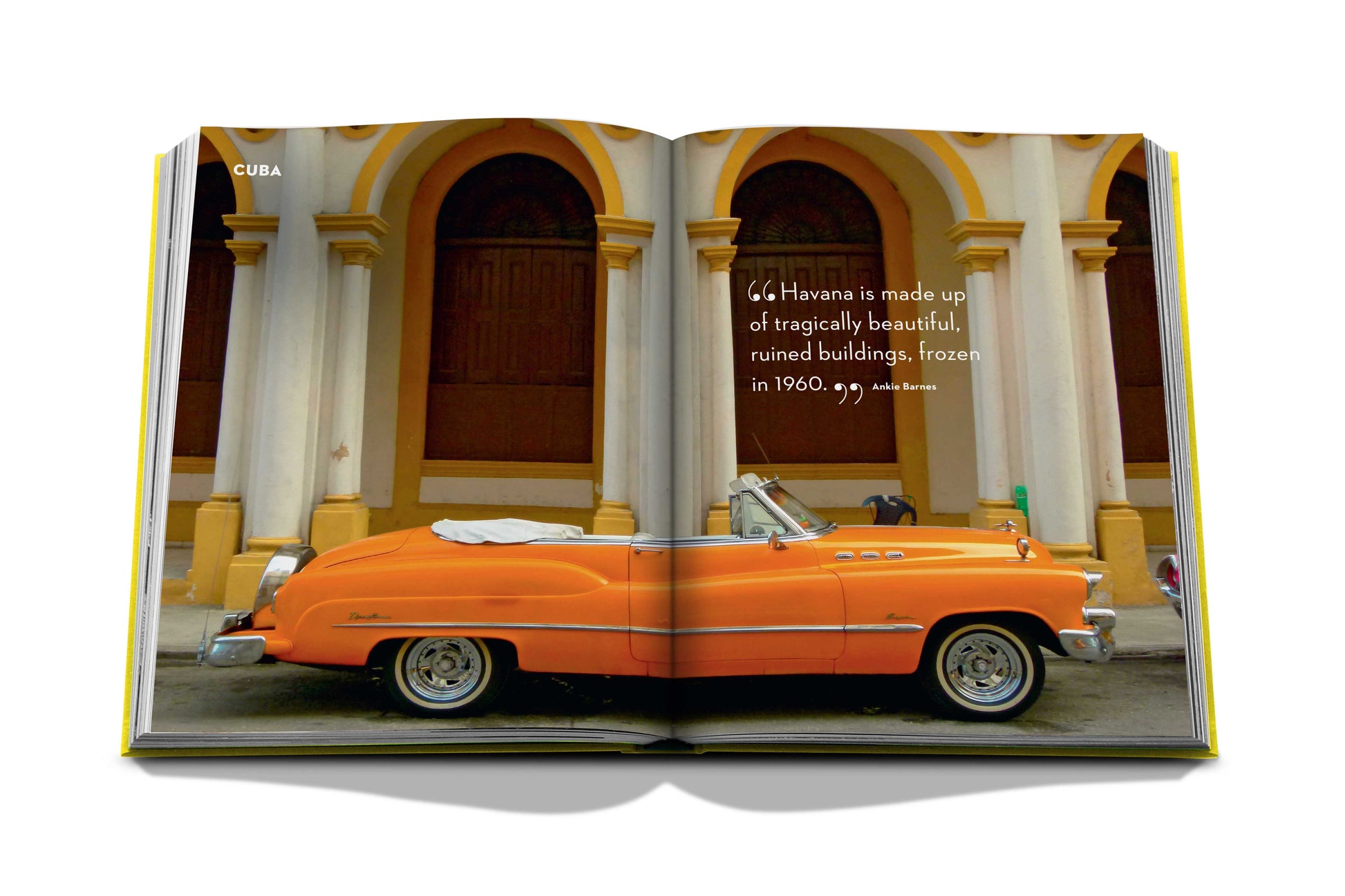 An orange Travel by Design car is parked in front of a building, making it a great spot for photographs.