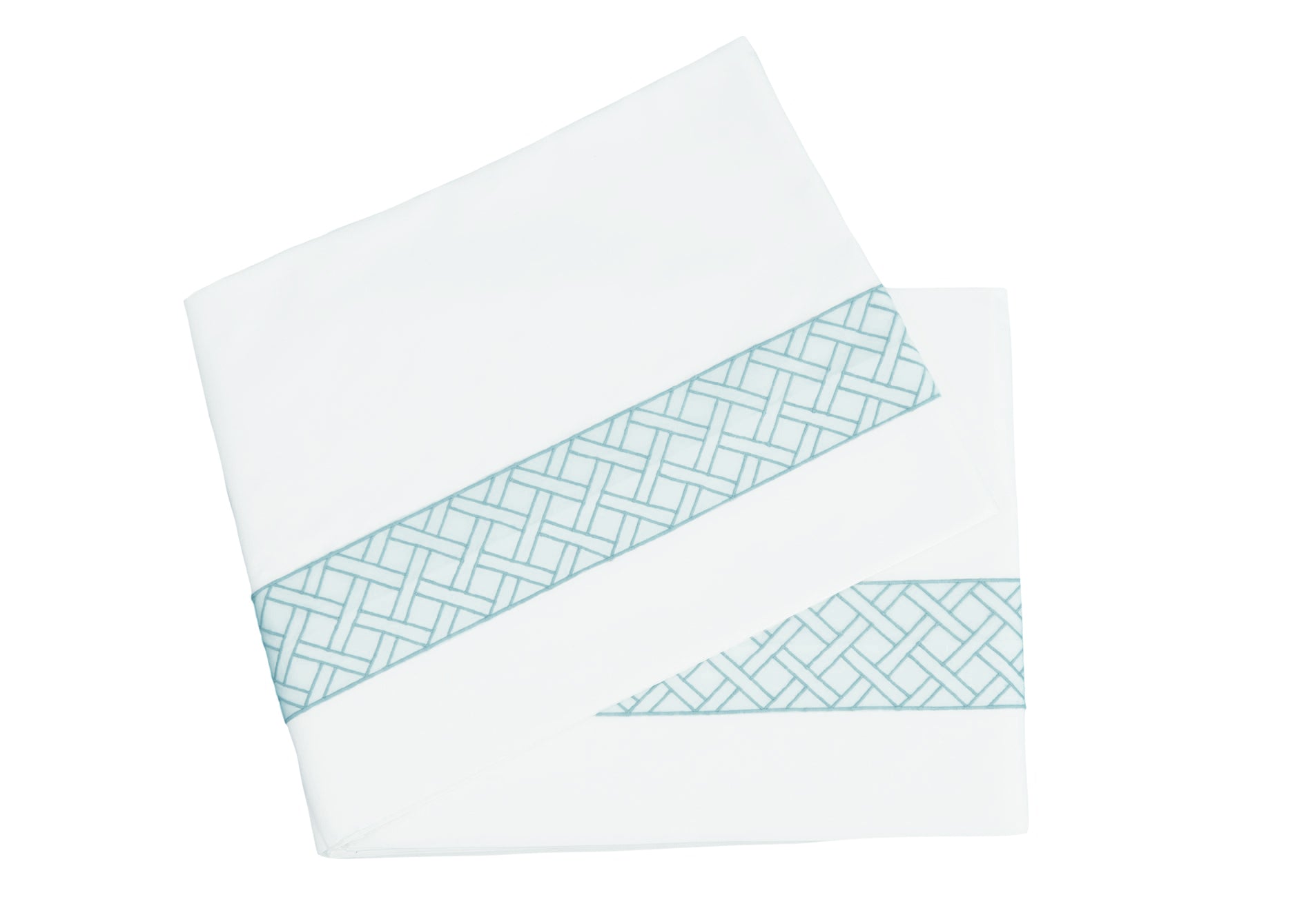 Two folded white sheets with a dark teal geometric lattice edge from the HIVE Exclusive Rovella Bedding Collection by Matouk, crafted in Egyptian cotton percale and OEKO-TEX® Standard 100 certified.