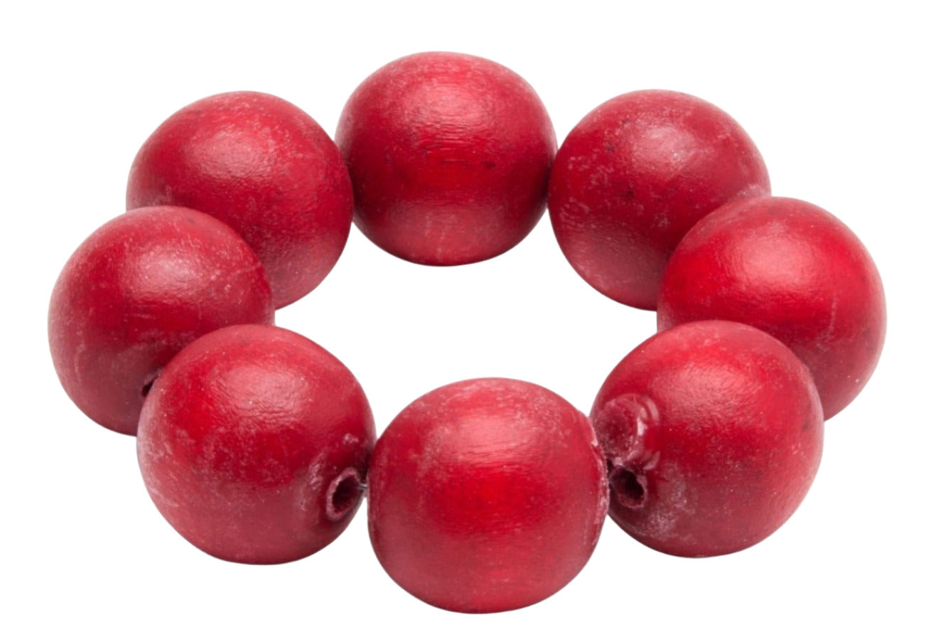 The Deborah Rhodes Cocoa Wood Bracelet Napkin Ring Set features a circular arrangement of seven large, red wood beads, creating a striking accent to elevate your place settings against a white background.