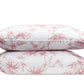 Two stacked pillows from the Matouk Dominique Bedding Collection in Blush with a tropical bamboos design on a white background.