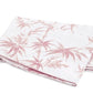 The Dominique Bedding Collection in Blush by Matouk features folded white Egyptian cotton percale with a pink bamboo leaf and floral pattern, and is OEKO-TEX® certified for quality and safety.