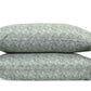 Two green and white Duma Diamond Bedding Collection pillows by Matouk, featuring a geometric pattern, are stacked against a white background.