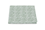 The Matouk Duma Diamond Bedding Collection quilt features a harlequin pattern in green and white, crafted from luxurious Egyptian cotton percale on a pristine white background.