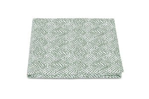 The Matouk Duma Diamond Bedding Collection quilt features a harlequin pattern in green and white, crafted from luxurious Egyptian cotton percale on a pristine white background.