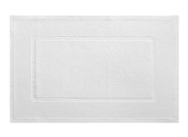 A Yves Delorme Eden Blanc bath mat made of 100% cotton on a white background.