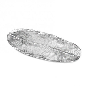 The Garden Banana Leaf Platter by Beatriz Ball is an extra large silver tray with detailed vein patterns, shaped like a long, narrow leaf—an elegant decorative serving platter for any occasion.