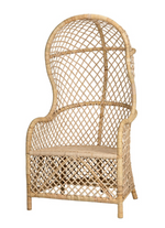 The Gigi Chair by Noir is an egg-shaped wicker chair featuring a high back, curved top, armrests, and a woven rattan design.