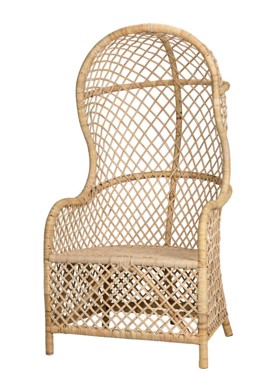 The Gigi Chair by Noir is an egg-shaped wicker chair featuring a high back, curved top, armrests, and a woven rattan design.