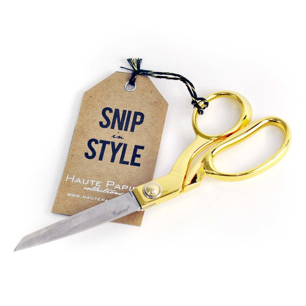 A pair of Haute Papier Gold Scissors with a tag that says snip style.
