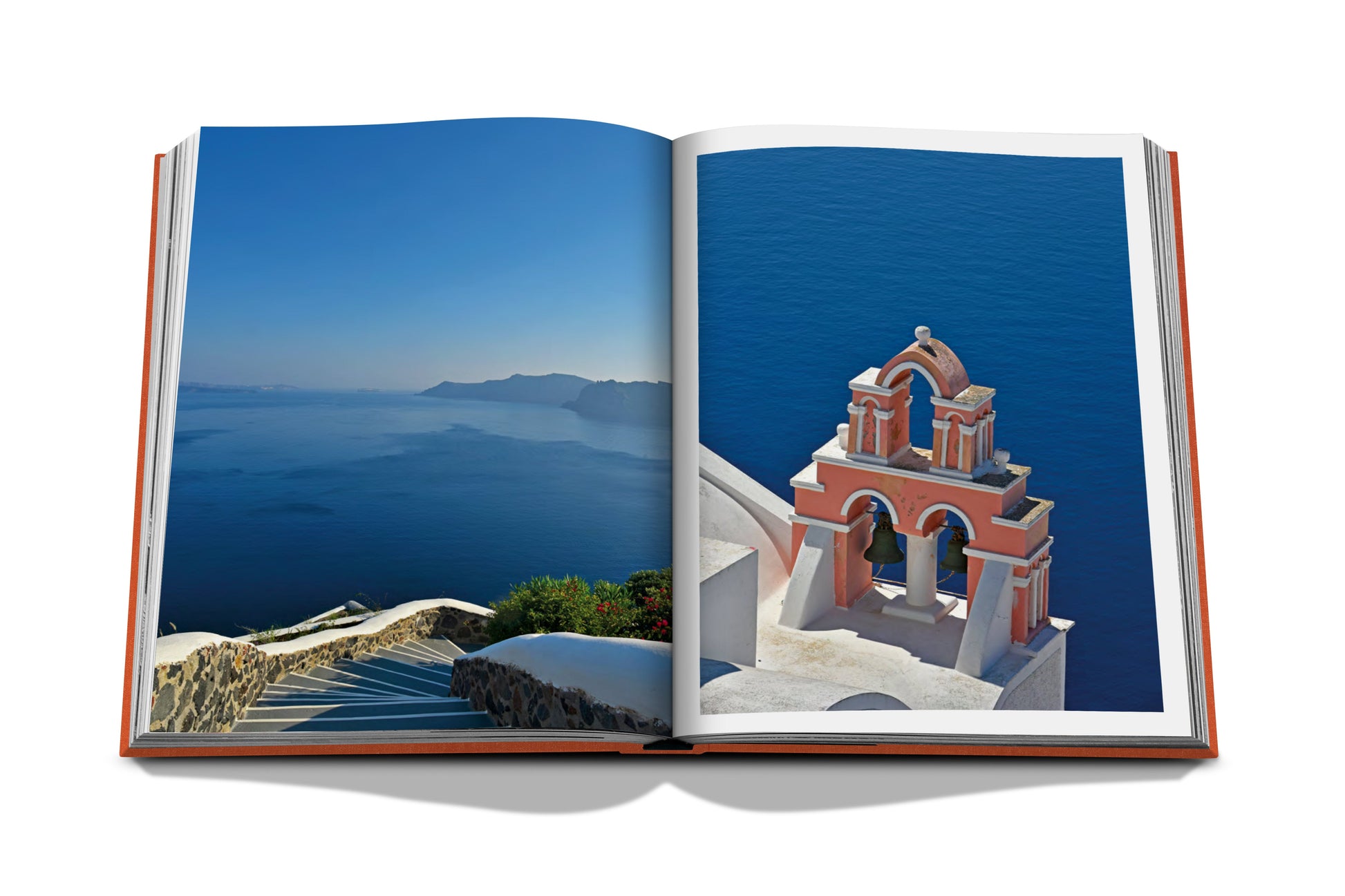 Open book displaying a photograph of a traditional Santorini church, embodying Greek hospitality and overlooking the Aegean Sea from Assouline's Greek Islands.