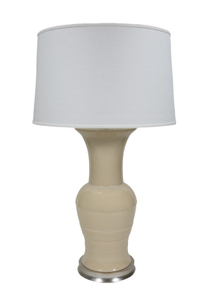 The Hwang Bishop Koi Lamp features a cream ceramic base with a warm silver circular base and a white fabric lampshade.